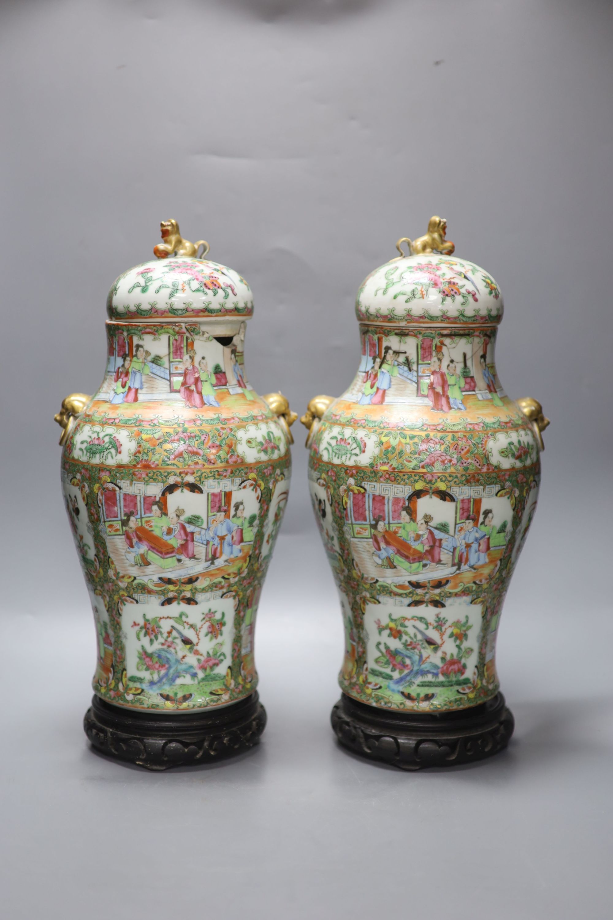 A pair of 19th century Cantonese vases and covers, with later stands, overall height 44cm (a.f.)